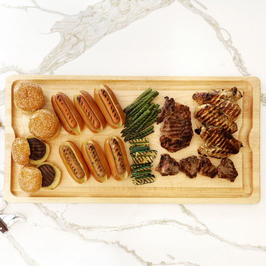 JK Adams Maple BBQ Board 36"x18" Lifestyle with grilled burgers, hot dogs, steak, chicken and veggies