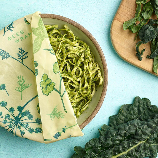 A bowl of pesto pasta wrapped in Bee's Wrap Herb Garden.