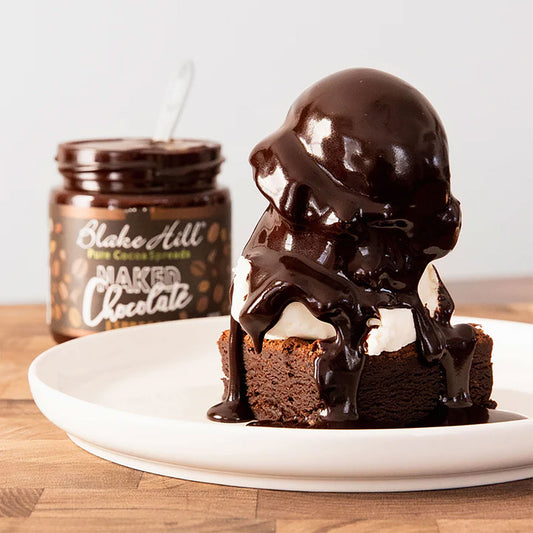 Chocolate dessert with a jar of chocolate spread on a wooden surface