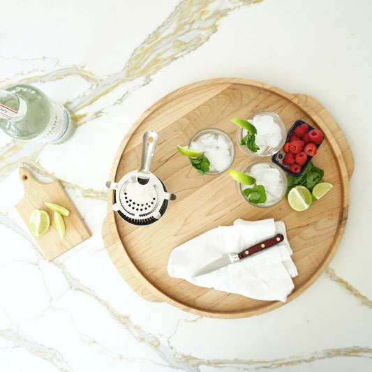 JK Adams 18" Round Tray with a cocktail shaker, drinks, raspberries, limes and mint.