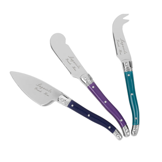 An angled view of 3 cheese knives with purple handles.