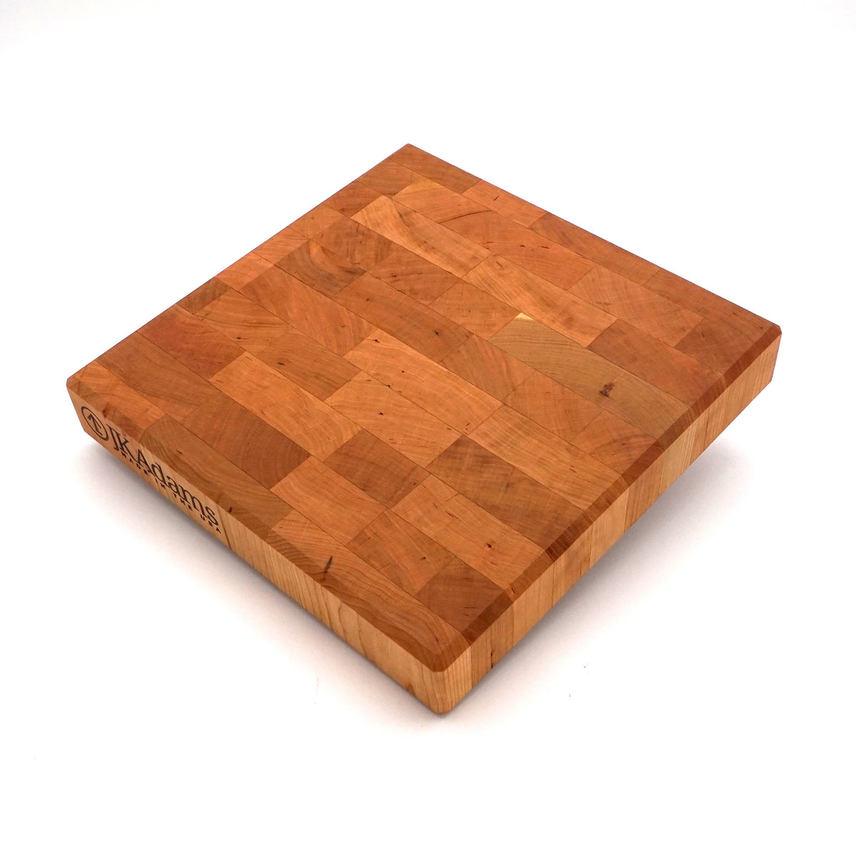 A square wooden butcher block cutting board with a warm honey-brown finish and visible end grain, photographed on a clean white background.